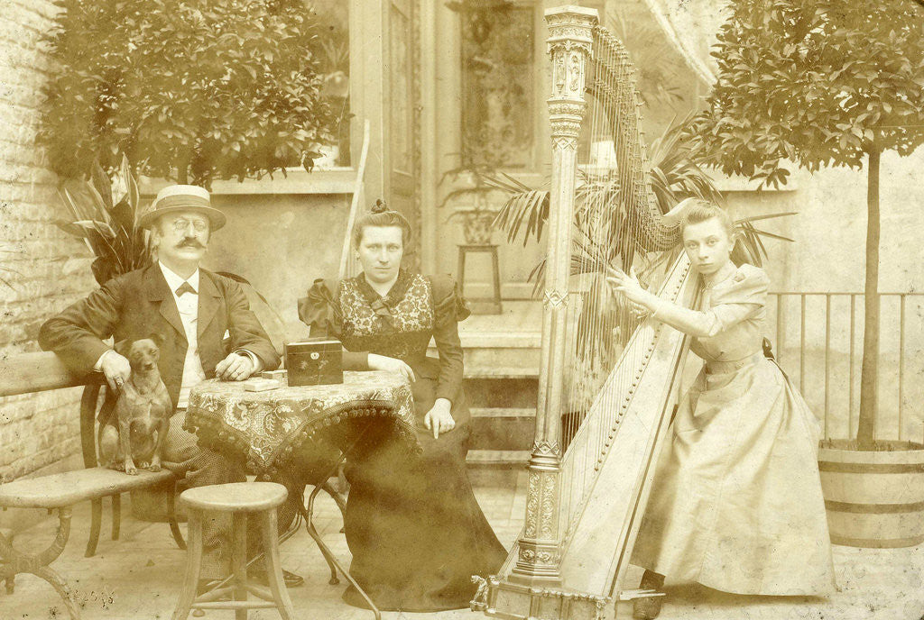 Detail of portrait of a dog sitting man seated woman and harp playing girl on a terrace by E. Dietrich