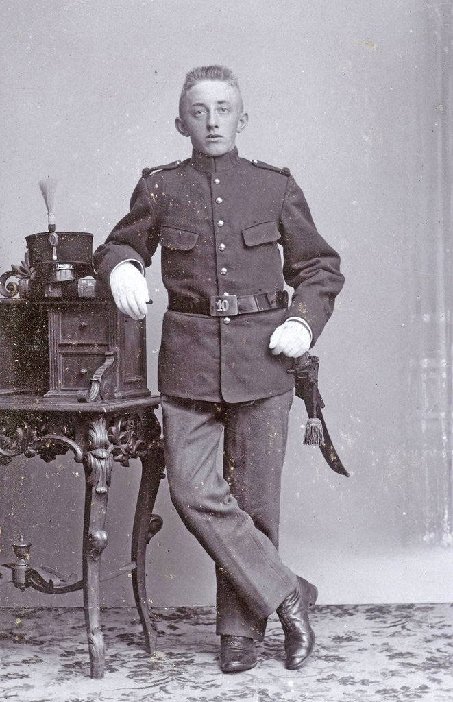 Detail of Studio portrait of man in uniform with dresser by J.L.T. Huijsen