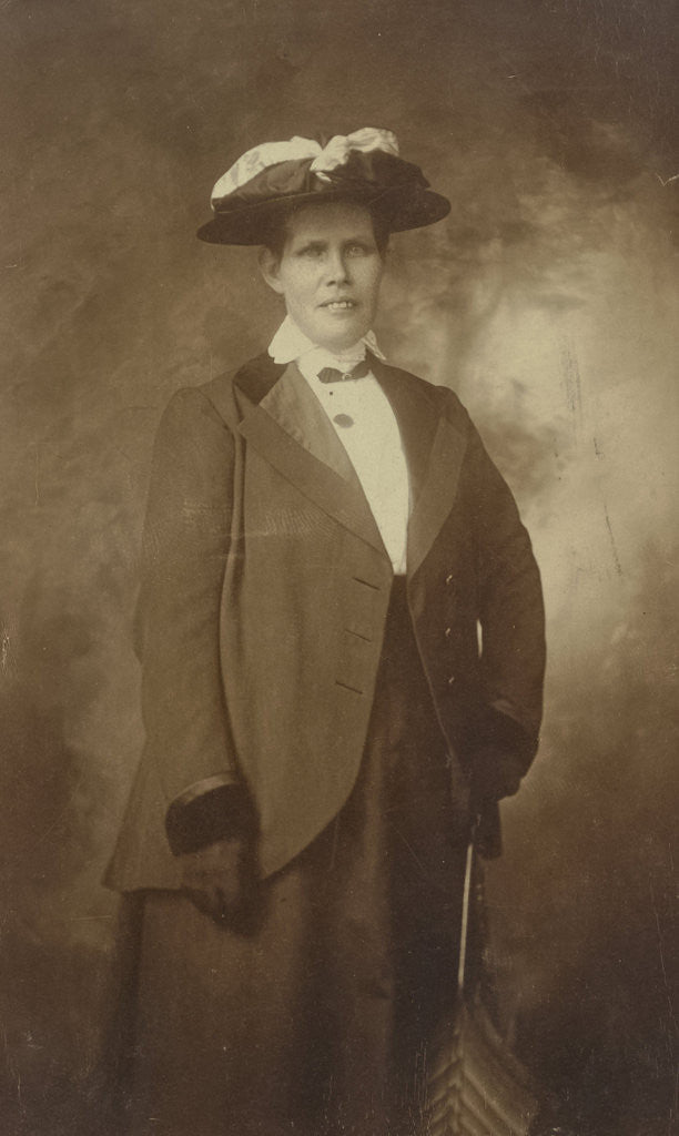 Detail of Portrait woman with jacket, hat and umbrella by Anonymous