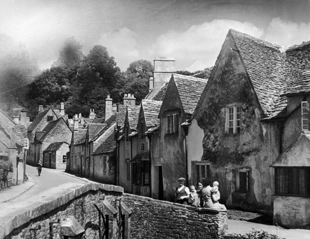 Detail of A family takes a rest on a stone wall in a Cotswold village in Gloucestershire by Anonymous
