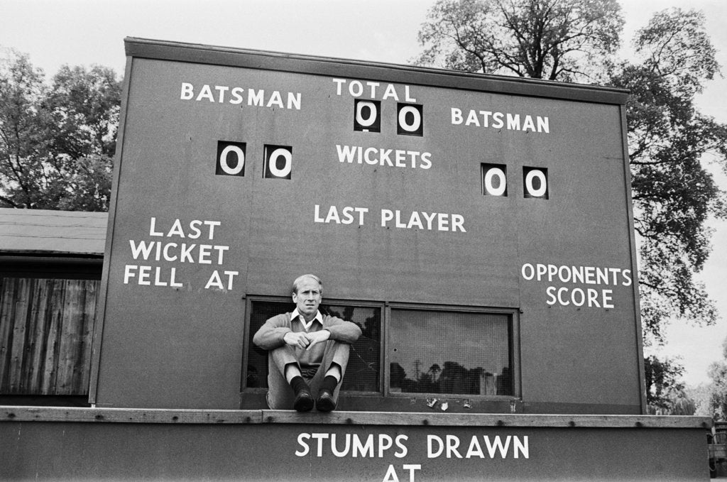 Detail of Bobby Charlton sits in front of a cricket scoreboard by Anonymous