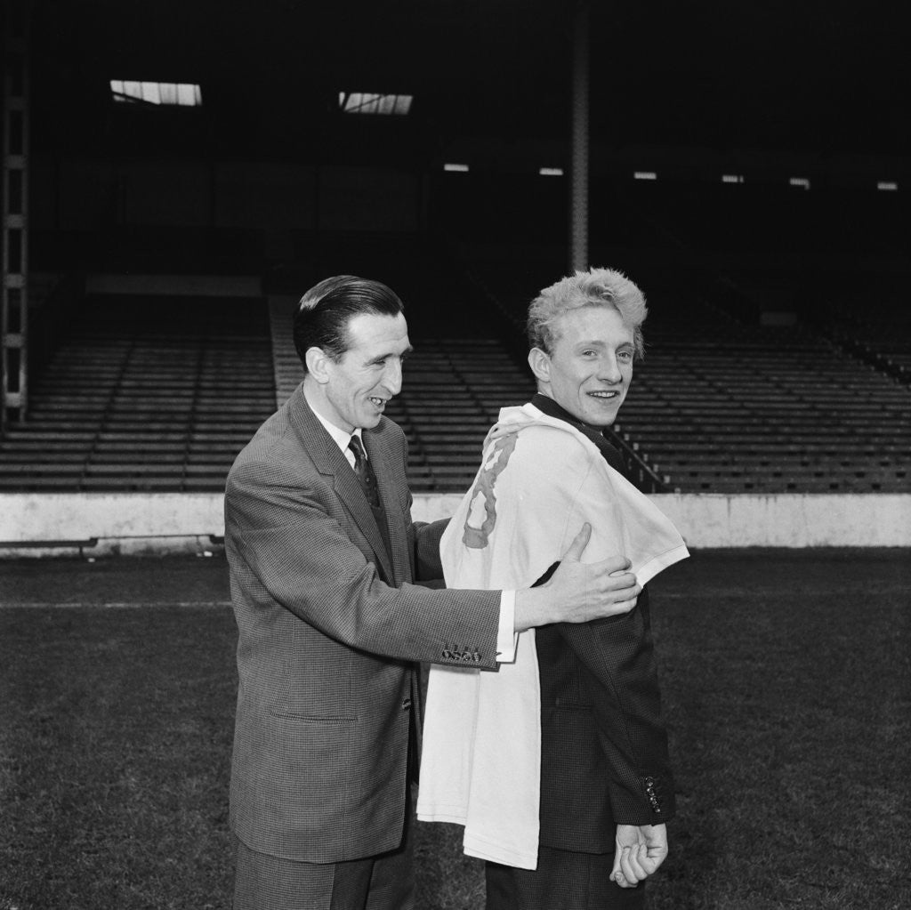 Detail of Manchester City new signing Denis Law with Ken Barnes trying his new shirt for size by Thomas