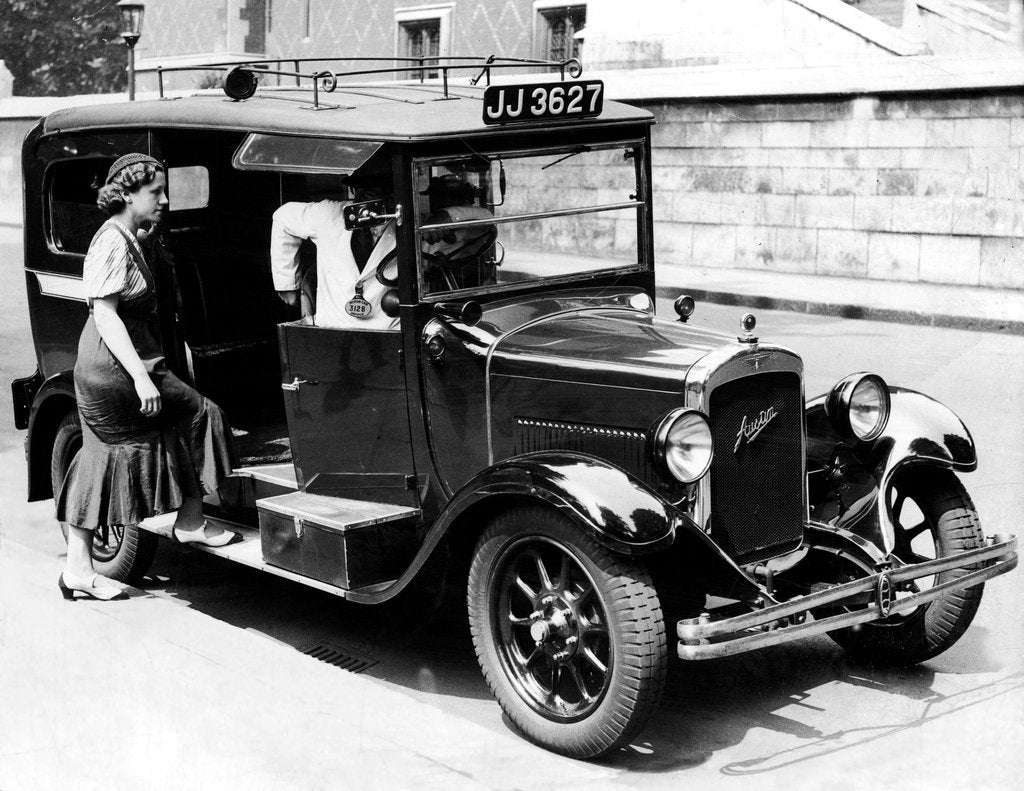 Detail of A female passenger entering one of the new London taxi cabs by Staff