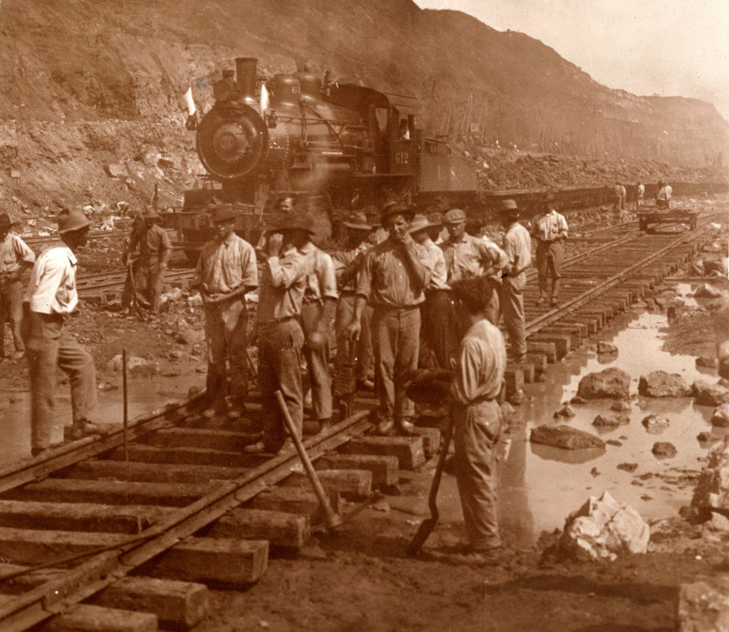 Detail of Spanish laborers at work in Culebra Cut and loaded train hauling dirt from canal, USA by Anonymous