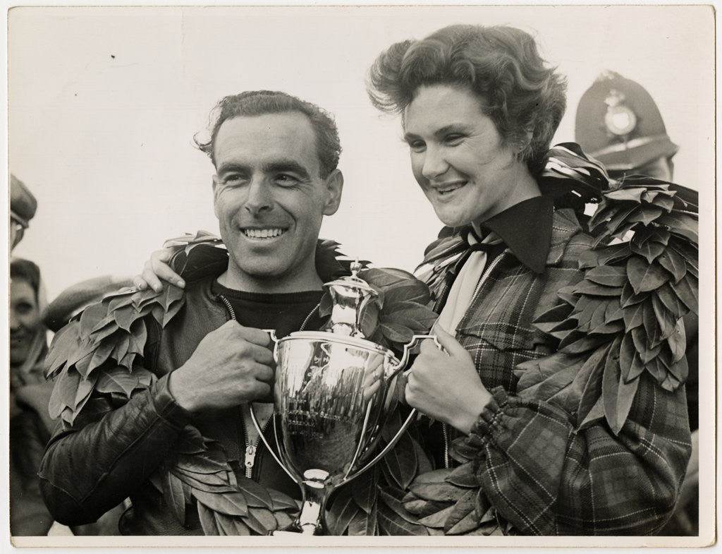 Detail of Sidercar TT (Tourist Trophy) crew holding a silver cup by T.M. Badger
