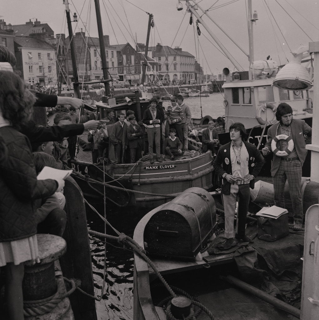 Detail of Radio Caroline disc jockeys Tony Prince and Dave Lee Travis on boat, East Quay, Ramsey Harbour by Manx Press Pictures