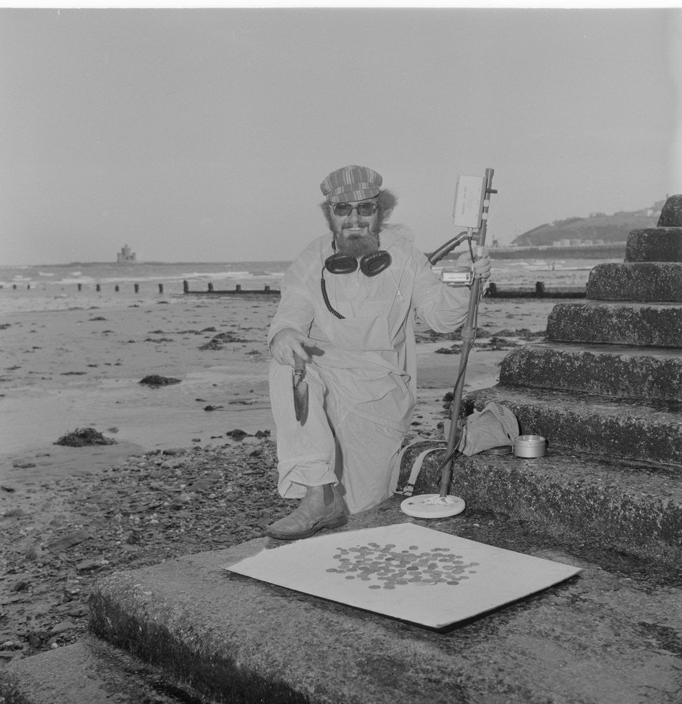 Detail of Metal detectorist on Douglas beach by Manx Press Pictures