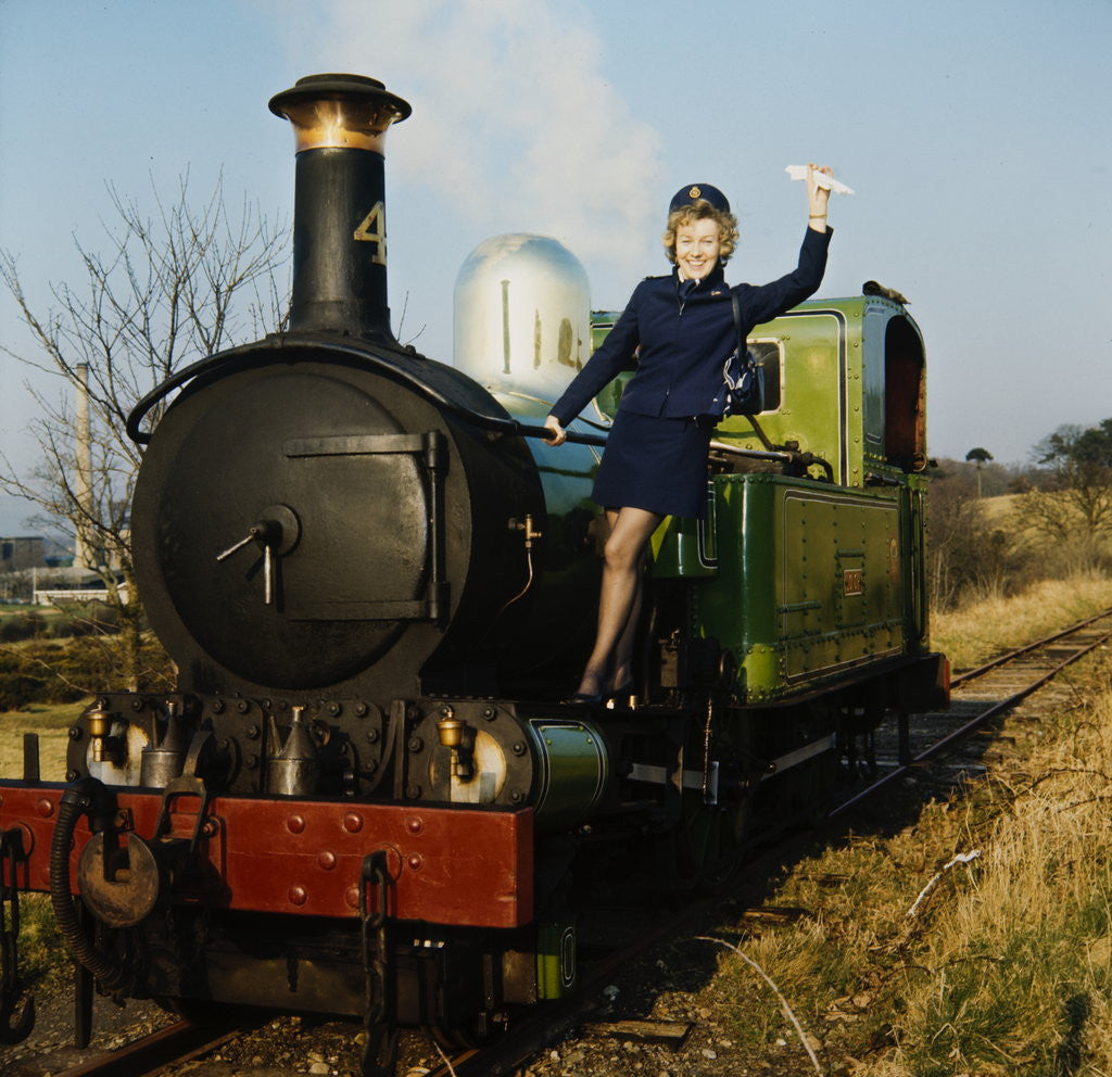 Detail of Air hostess hanging-off side of steam train by Manx Press Pictures