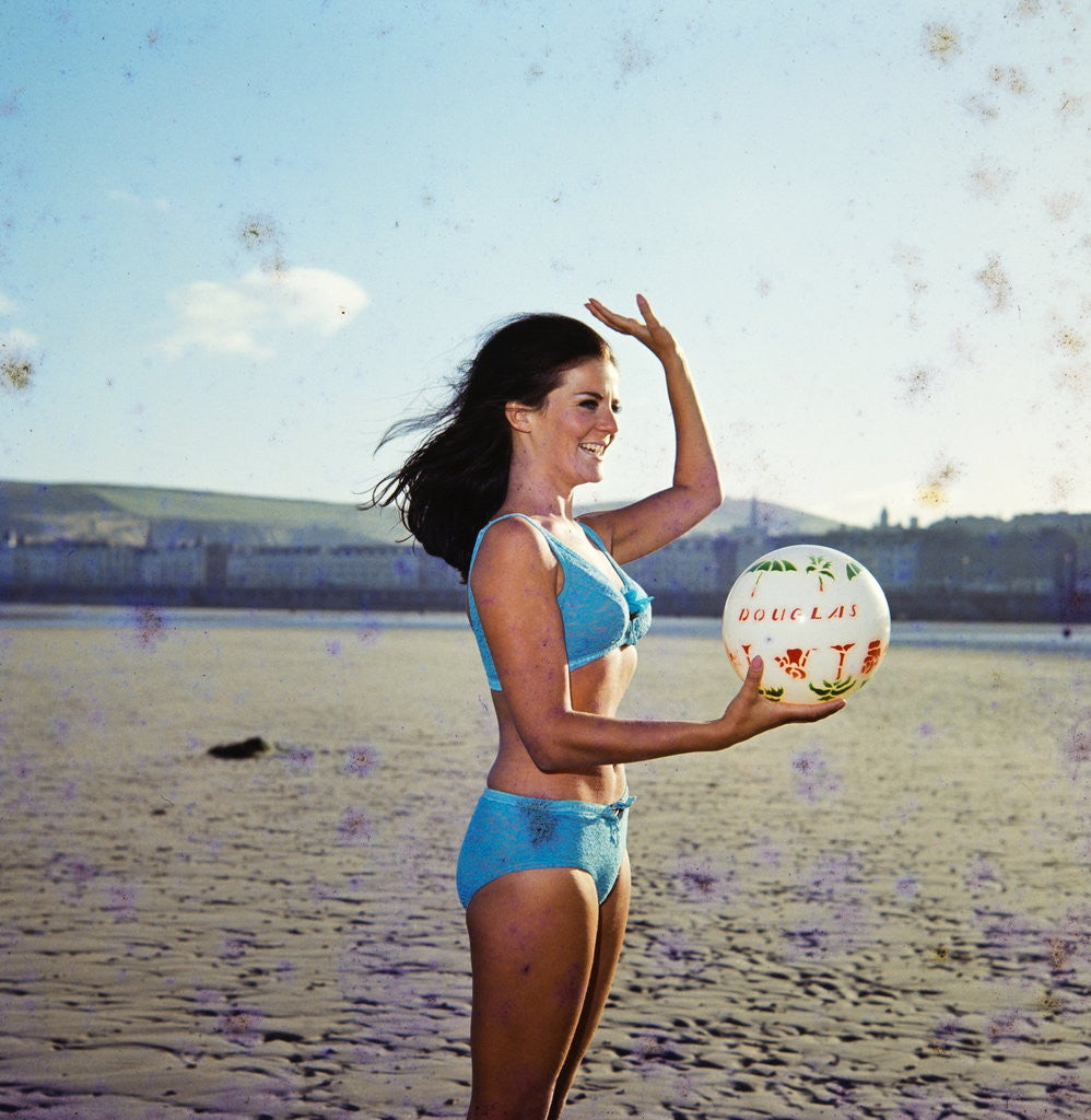 Detail of Glamour girl on Douglas beach with beachball by Manx Press Pictures
