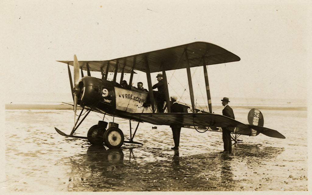 Detail of Plane No. 9 on the shore at Ramsey belonging to A.V. Roe and Co. Ltd. G.W. Kewin, town surveyor climbing into the cockpit by Thomas Horsfell Midwood