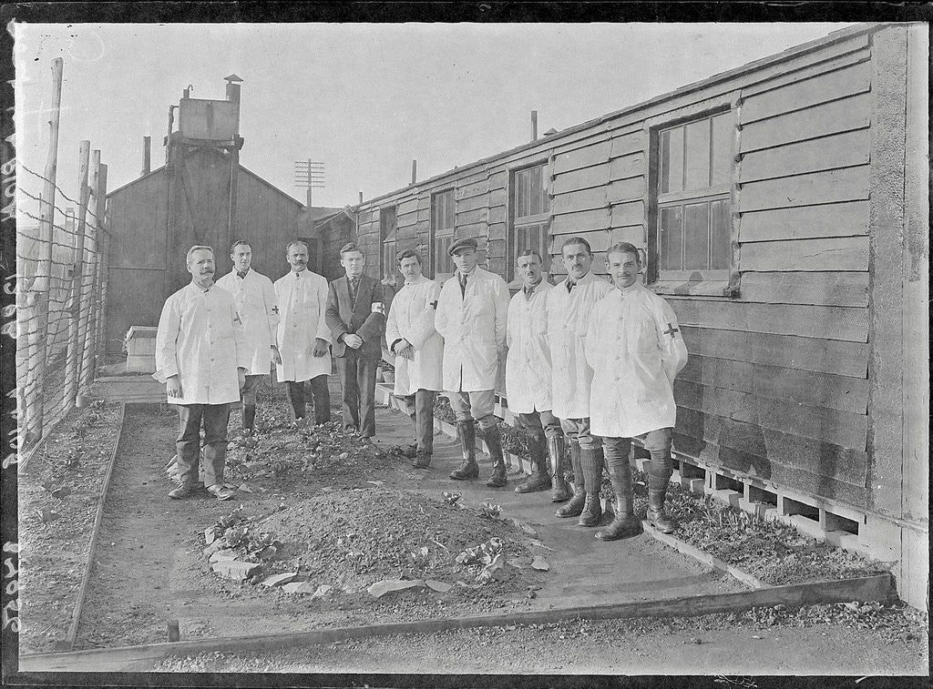 Detail of First World War Internee in front of hut with medical/hospital staff, Camp 2, Knockaloe by W H Warburton