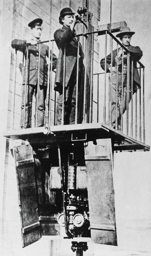 Detail of Men Atop Exhibition's Electric Elevator by Anonymous