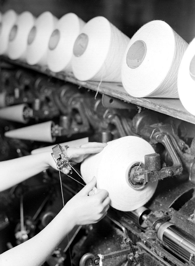 Detail of High Point, North Carolina - Textiles. Pickett Yarn Mill. Winder operator by Lewis Hine
