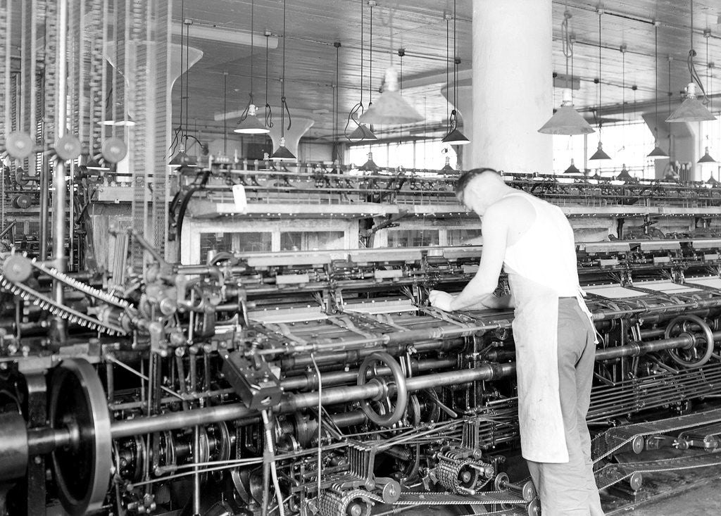 Detail of Philadelphia, Pennsylvania - Hosiery. Minnesac Mills. Man working over long row of machines, 1936 by Lewis Hine