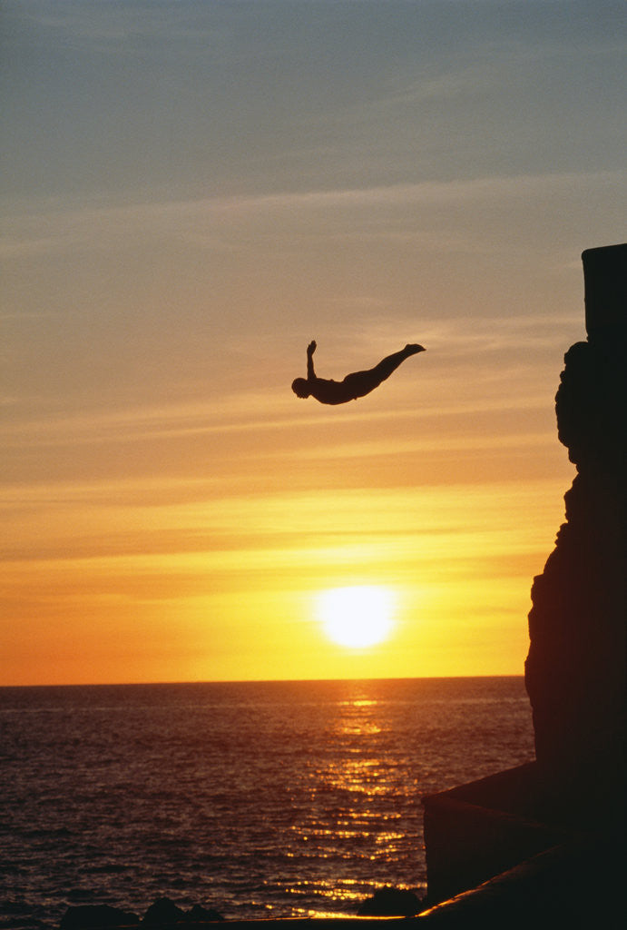 Detail of Cliff Diver Above Setting Sun by Corbis