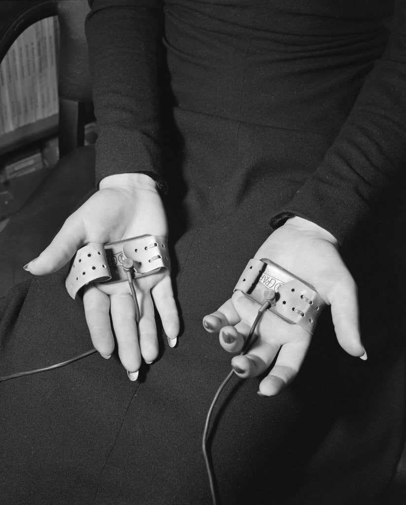 Detail of Pair of Hands Wearing Lie Detector Device by Anonymous