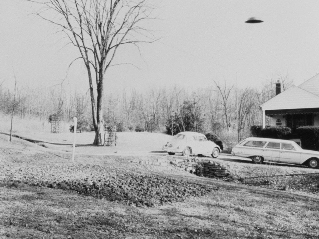 Detail of Unidentified Flying Object Flying Over House by Corbis