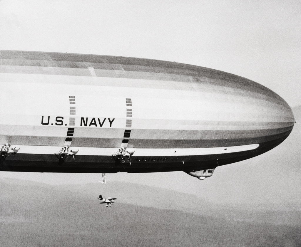 Detail of Plane Underneath Huge Dirigible in Flight by Anonymous