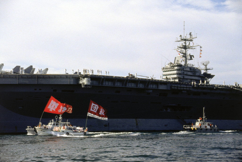 Detail of Ship and Boats with Flag Carriers Against the Nuclear Vessel by Corbis