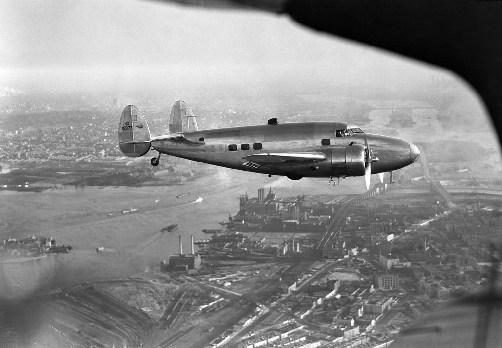 Detail of Howard Hughes Lockheed 14 Super Electra over New York City by Corbis