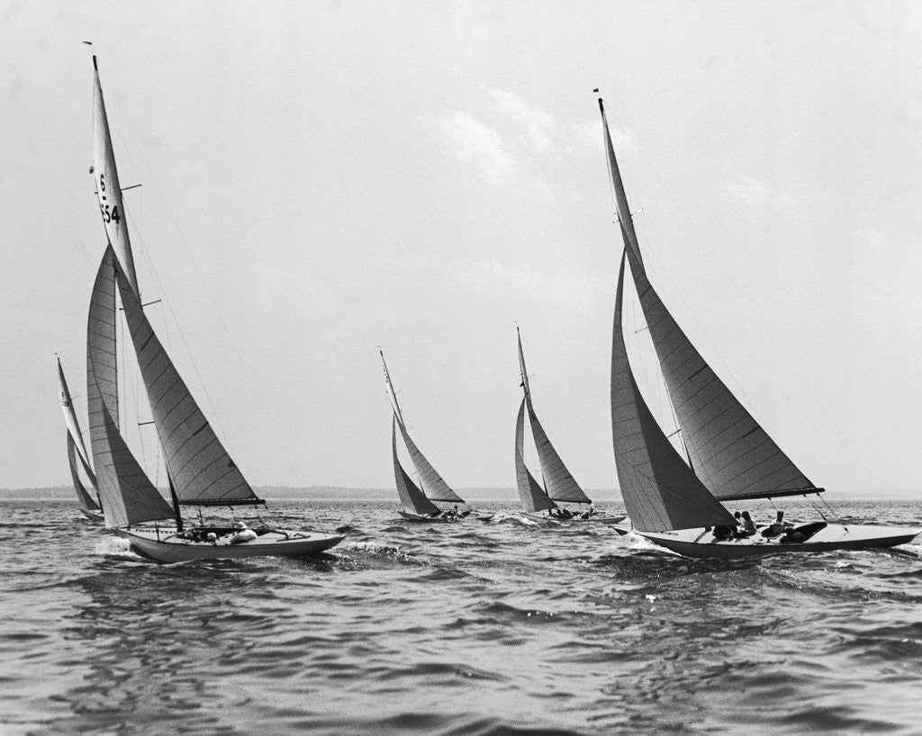 Detail of Six Meter Sailboats Leaning in Race by Corbis
