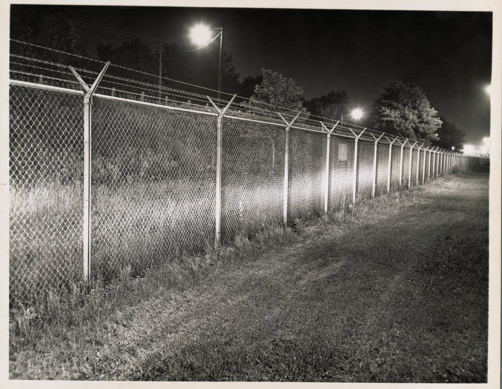 Detail of Metal Fence with Barbed Wire by Anonymous