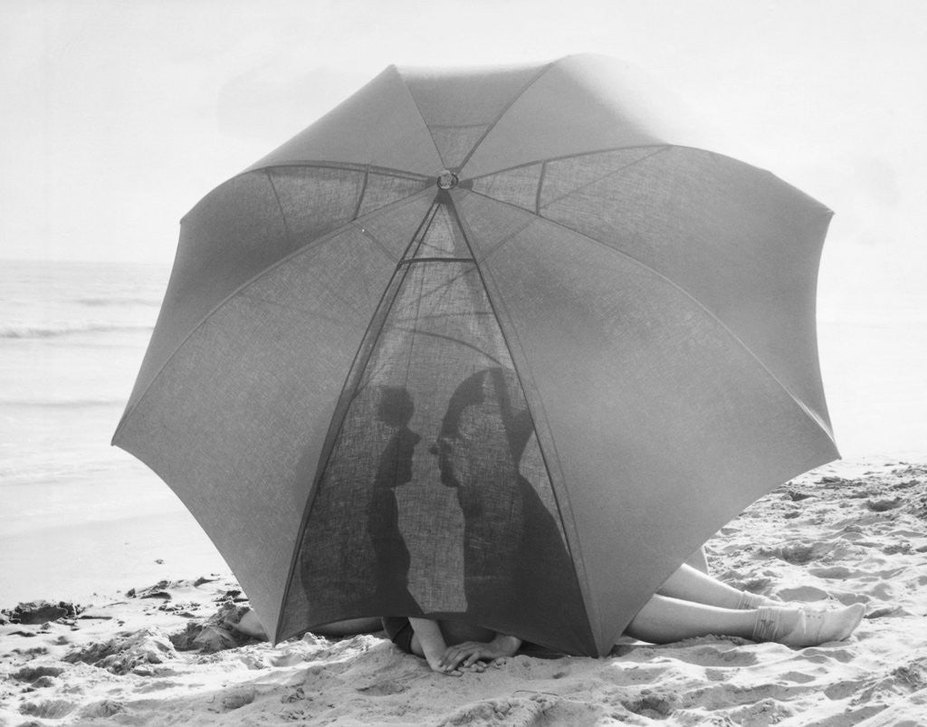 Detail of Couple on Beach Under Umbrella by Anonymous