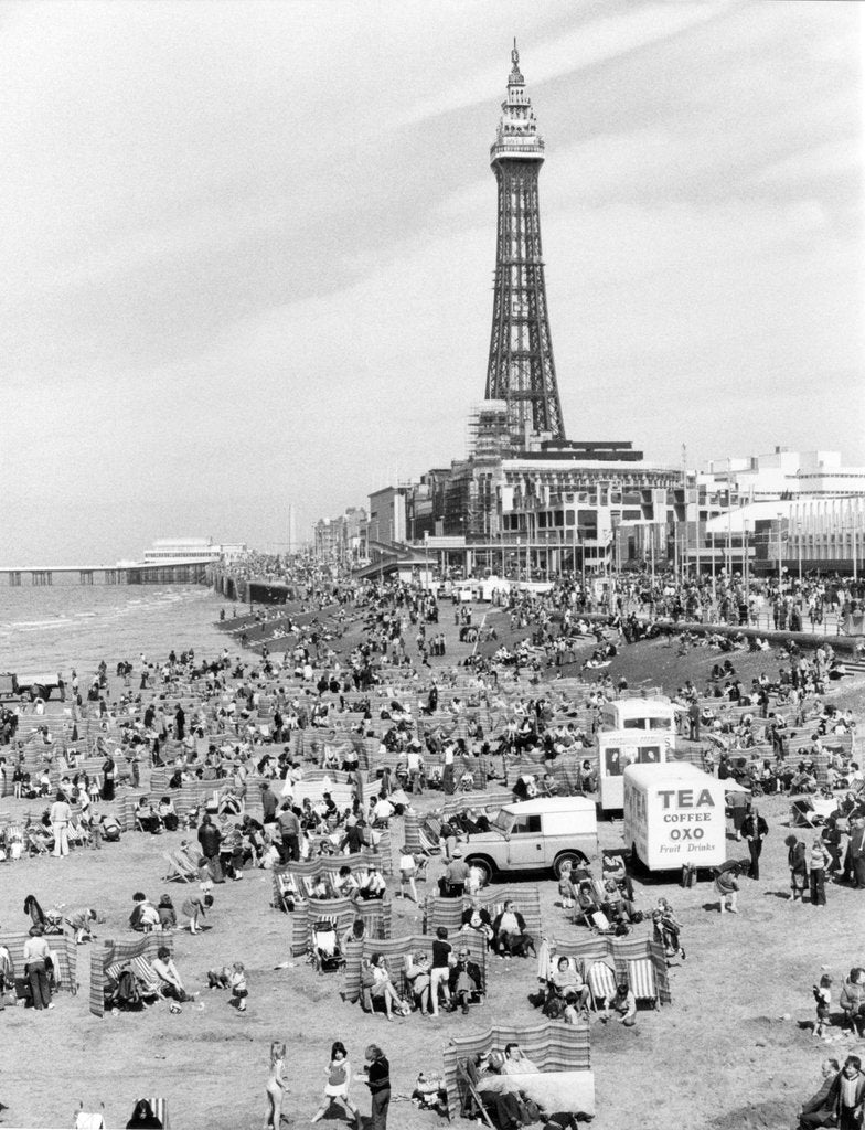 Detail of Blackpool Tower with people sitting on Blackpool Beach by Anonymous