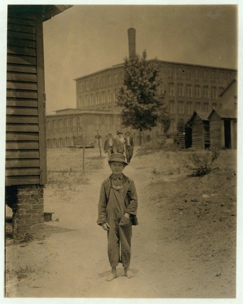 Detail of 12 year old Eddie Norton, makes about 40 cents a day as a sweeper at Saxon Mill, Spartanburg, North Carolina, 1912 by Lewis Wickes Hine