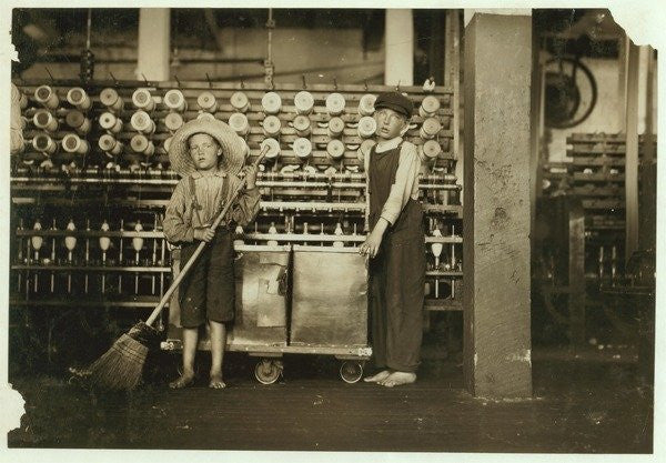 Detail of 12 year old doffer Ronald Webb and 7 year old Frank Robinson, son of cardroom boss, who sweeps and doffs (clears full bobbins) by Lewis Wickes Hine