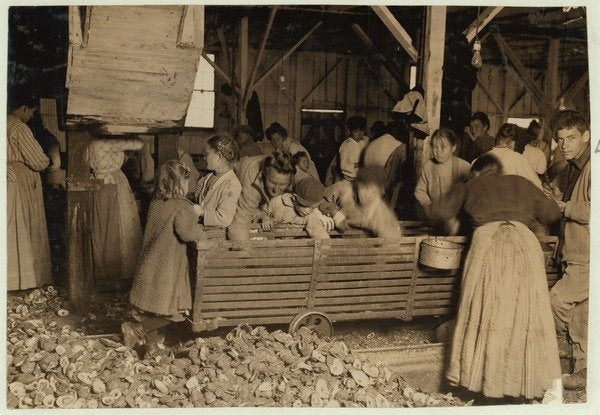 Detail of Bill May, aged 5 who makes 15 cents a day, in the shucking shed at Barataria Canning Company, Biloxi, Mississippi, 1911 by Lewis Wickes Hine