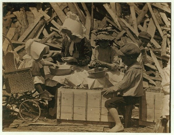 Detail of 2 year old Cyral hulling strawberries from his cart at Johnson's Hulling Station, Seaford, Delaware, sometimes falling asleep for a few minutes by Lewis Wickes Hine